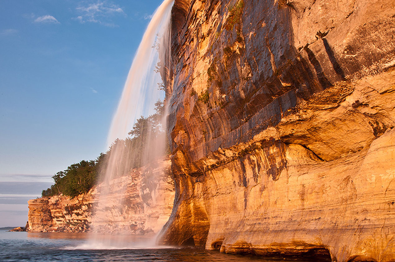 Spray Falls near Sunset as seen from a boat cruise tour.