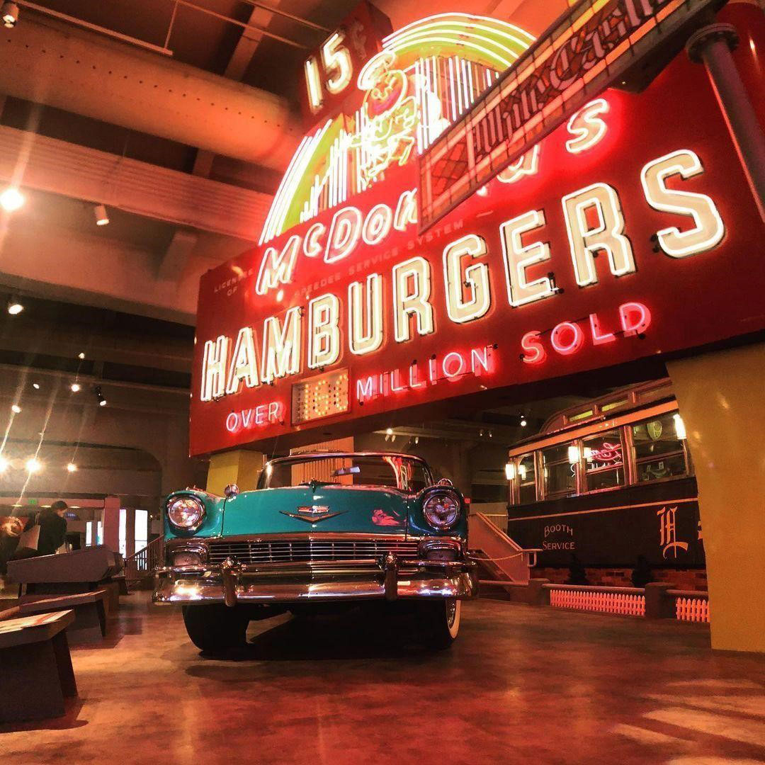 A replica of the first McDonald’s chain next to a classic car at the Henry Ford Museum
