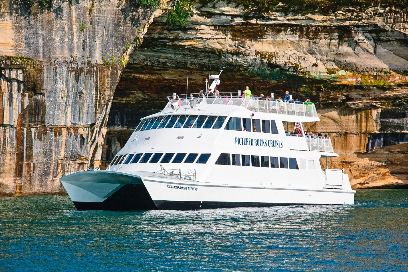Pictured Rocks Cruises gliding closely past the painted cliffs in the Pictured Rocks Park